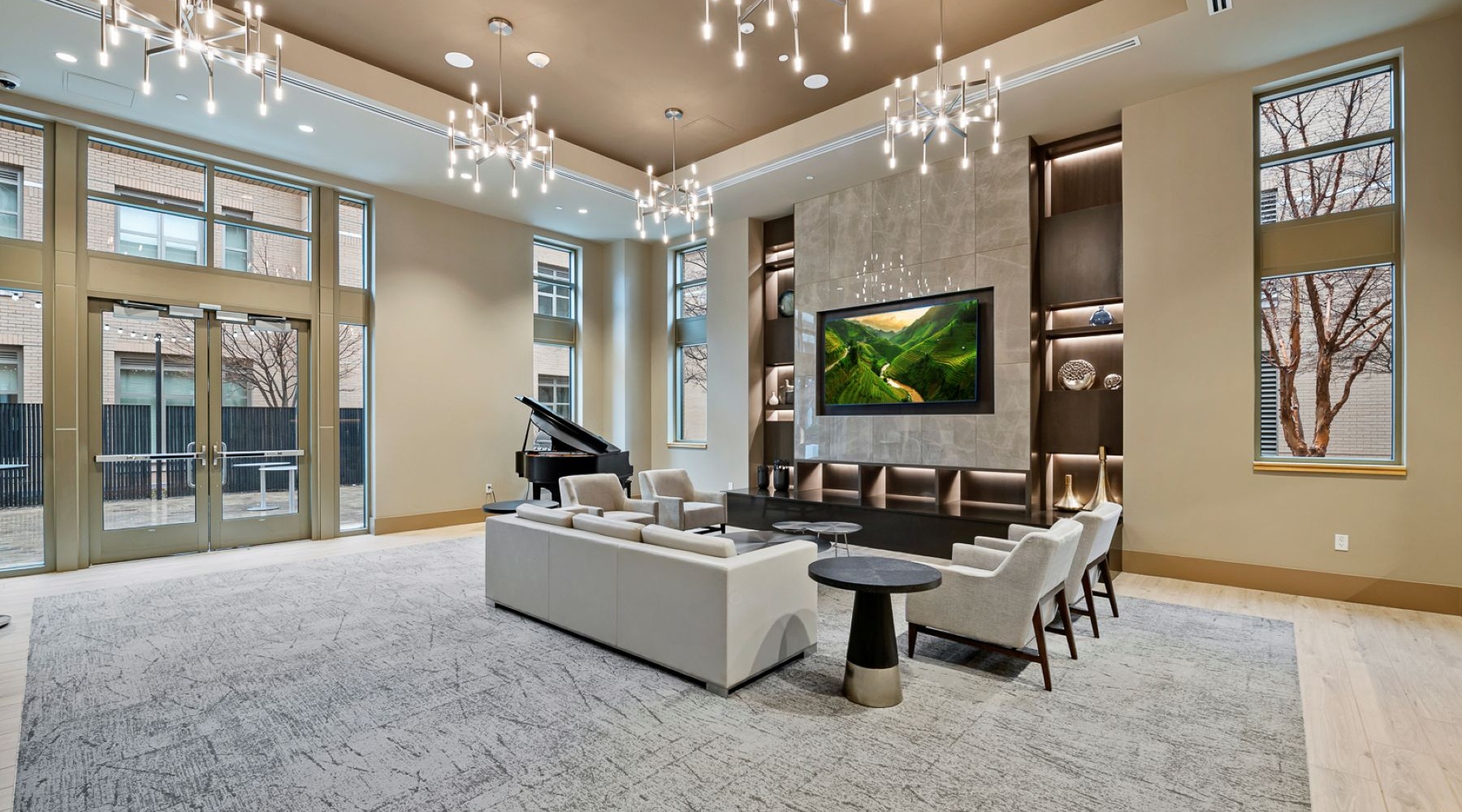 large lounge with seating and tv and windows