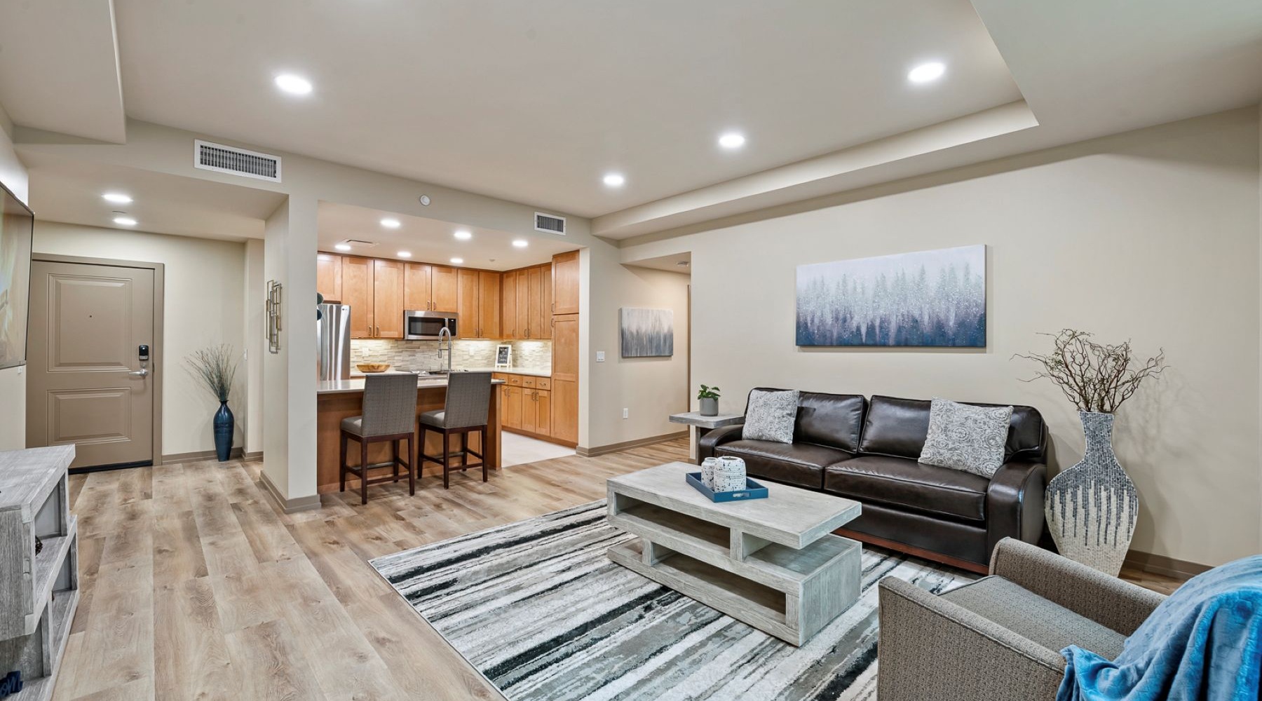 living room with couch coffee table and view of a kitchen