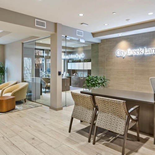 a room with a table chairs and a tv